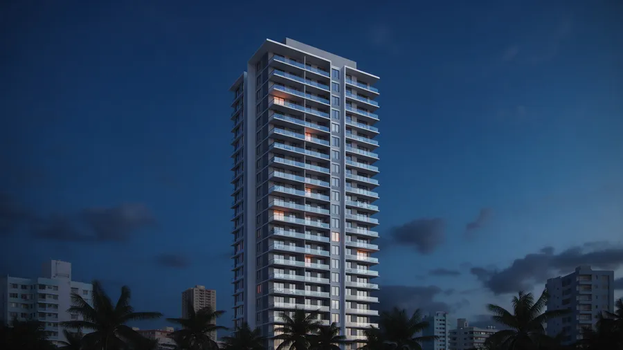 Torre residencial al anochecer con algunas ventanas encendidas